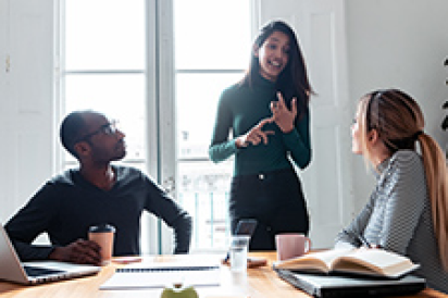 three people in office talking